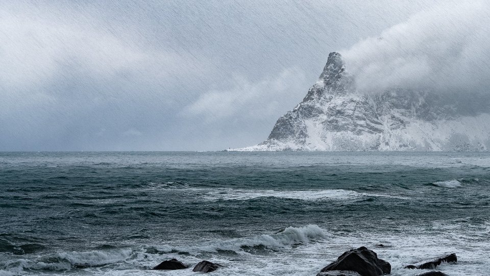 Cold coastal landscape with rough water and sea spray