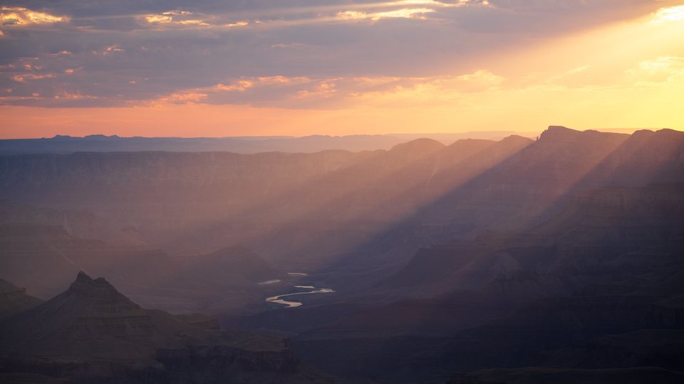 Dust and haze suspended above a canyon landscape