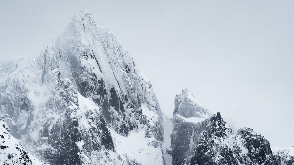 Snow-covered mountain peaks in winter conditions
