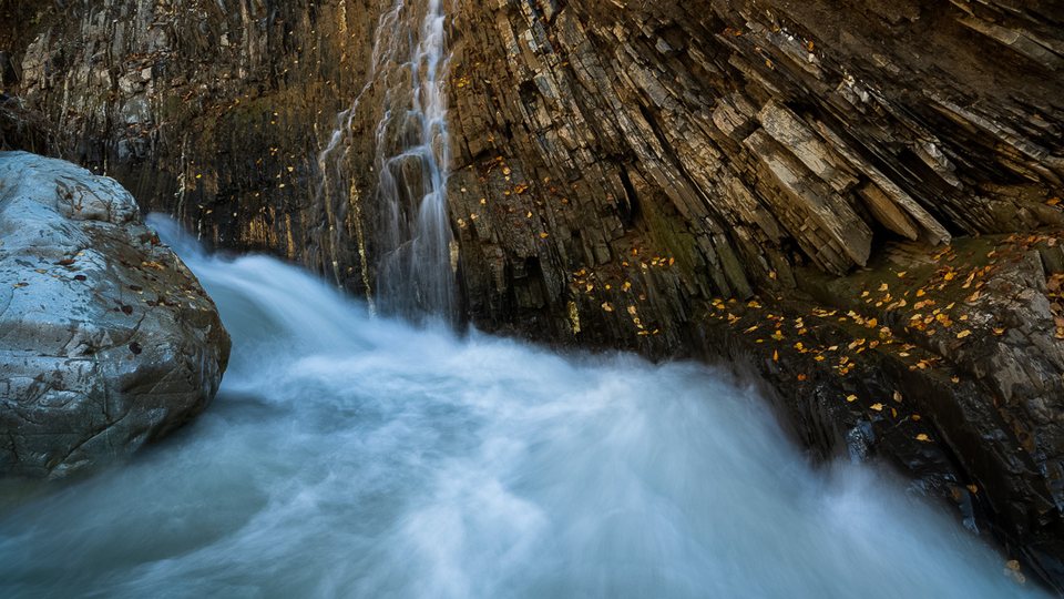 Blue river water flowing through a rocky gorge